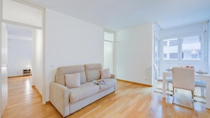 A modern living room with a sofa, a dining table, and a chair. - Locarno Best Place near Piazza Grande and Lake, Locarno, Switzerland (Locarno)