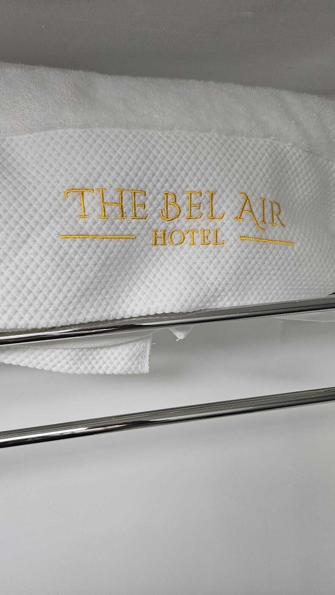 A white towel with embroidered text reading "THE BEL AIR HOTEL".