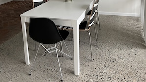 A modern dining area with a white table, black chairs, and a striped vase. A television is on a stand against the wall, and a framed picture hangs above the table. - 'The Savoy'. Central home with pool. Pet friendly (Port Macquarie)