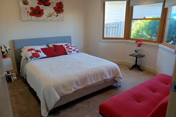 Red Tulip bedroom overlooking front garden: 1 queen bed and futon sofa bed.