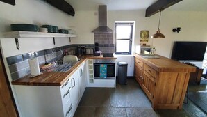 A compact kitchen with a central island, a microwave, and a sink. - Bonneys Barn Retreat - Luxury homely getaway (000)
