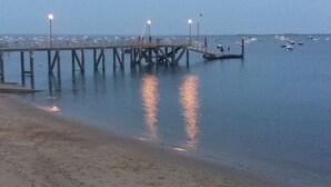 A pier extending into calm waters with a sandy beach in the foreground. - Apartment (Lège-Cap-Ferret)
