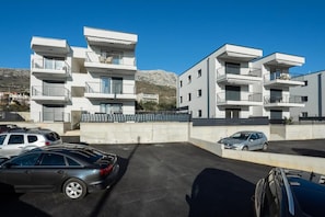 Residential building with balconies and scenic views.