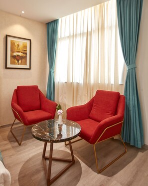 Deluxe Room | Living area | 32-inch LED TV with cable channels, TV - Indreni Suites Hotel (Kathmandu)