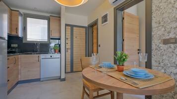 Deluxe Room, Pool View | Private kitchen | Mini-fridge, stovetop, dishwasher, cleaning supplies