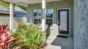 A modern house with a covered porch, a mailbox, and a door with a number plate. - Beach House - The Starfish By Panhandle Getaways (Panama City Beach)