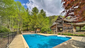 A swimming pool with a wooden deck, surrounded by trees and a cabin. - Mars Hill Cabin w/ Pool Table ~ 2 Mi to Wolf Ridge (Mars Hill)