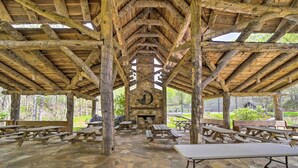 A rustic outdoor pavilion with stone flooring, wooden benches, picnic tables, and a stone fireplace. - Mars Hill Cabin w/ Pool Table ~ 2 Mi to Wolf Ridge (Mars Hill)