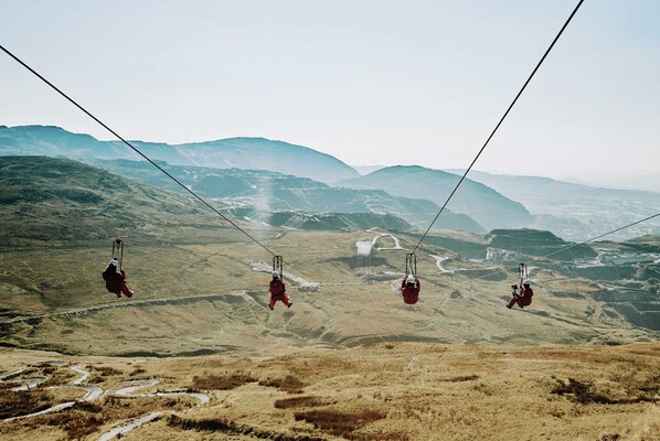 A cable car system in a mountainous area with a clear view of the landscape. - Barn conversion at the old Watermill - Snowdonia & Zip Line close by. (Pentir)