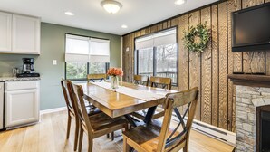 A dining area with a wooden table and chairs, a coffee maker, and a fireplace. - Pocono Lake Home w/ Fire Pit: Walk to Ski Hill! (Pocono Lake)