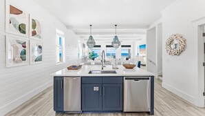A modern kitchen with a central island, stainless steel appliances, and pendant lighting. - Wilder Dreams - Gulf Front, Pool, Gated Community, Steps to Rosemary Beach (Seacrest)