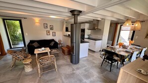A modern living space with a kitchen, dining area, and seating area.