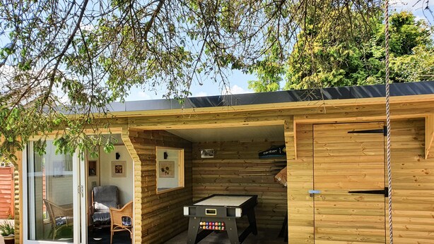 A wooden cabin with a pool table, a chair, and a door. - 17 Costa Way (Pickering)