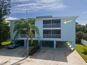 A two-story building with a blue exterior, numbered 3703, and a visible balcony on the second floor.