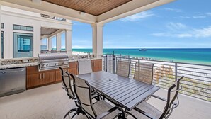 A covered outdoor kitchen with a view of the ocean. - Gulf-Front with Rooftop Deck, Theater and Pool (Miramar Beach)