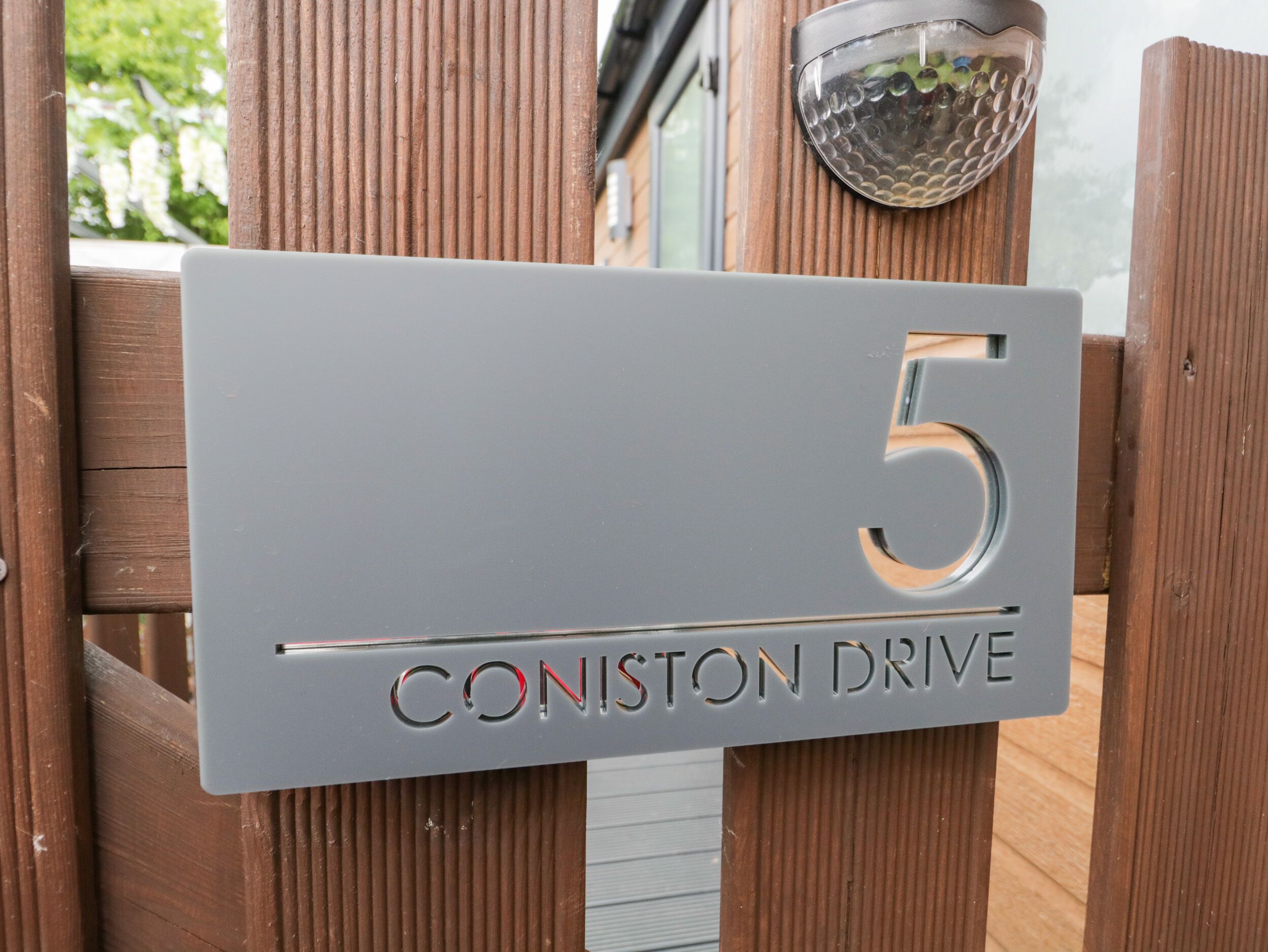 A house number sign with "5" and "Coniston Drive" indicating the address.