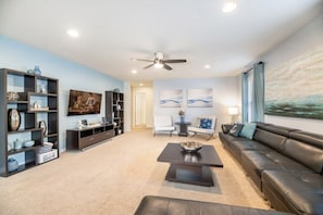 Relax in this stylish living room with a sofa, coffee table, and flat-screen TV.
