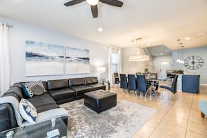 Relax in this stylish living room with a comfortable sofa, coffee table, and dining area.