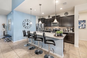 Enjoy meals in the kitchen with a central island and dining area.