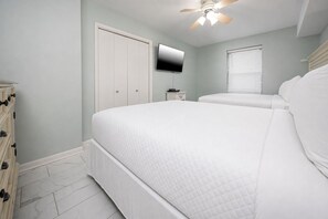 A bedroom with a bed, a dresser, a television, and a ceiling fan. - 🌊Phoenix VII 7401 - Beautiful Gulf Front Condo🌊 (Orange Beach)