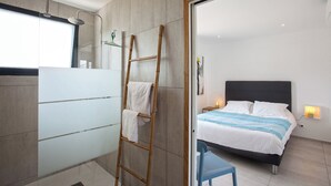 A modern bathroom with a glass shower enclosure, a wooden ladder, and a towel rack. - apart Levante shared swimming pool, bbq (Calenzana)