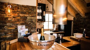 A kitchen with a stone wall, wooden countertop, and a large silver bowl labeled "DUVAL-LIN". - Chalet, balcony, parking, tv, ski locker, 130m², Valloire (Valloire)