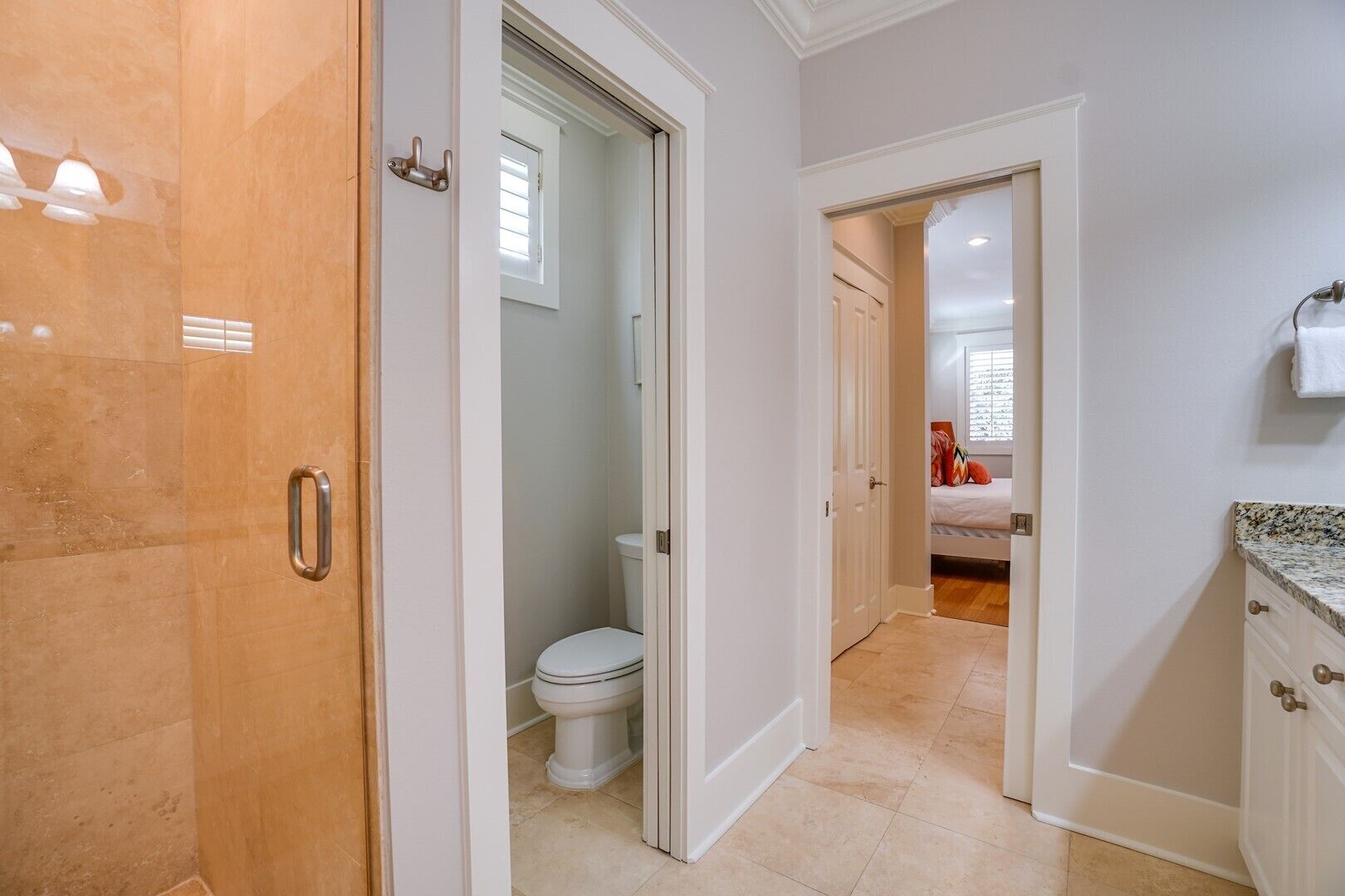 A modern bathroom with a toilet, shower, and vanity.