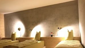 A room with three beds arranged in a row, each with a pillow and a lamp. - Magnificent architect-designed chalet, breathtaking view of Mont Blanc (Hauteluce)