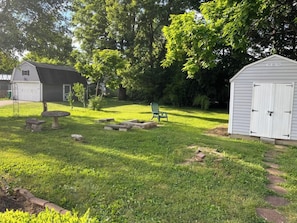 A backyard with a picnic table, a small shed, and a lawn. - Main, Three Bedroom House in Historic Loveland (Loveland)