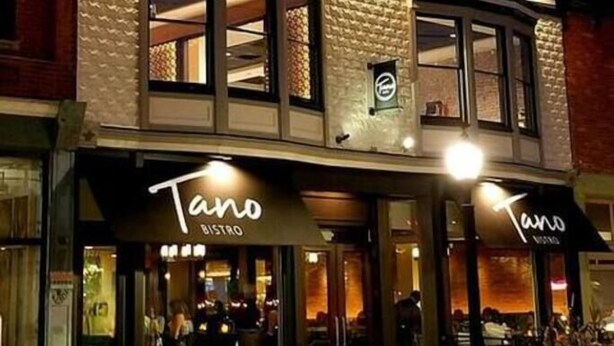 A building with two storefronts labeled "Tano BISTRO" with illuminated signage. - Main, Three Bedroom House in Historic Loveland (Loveland)