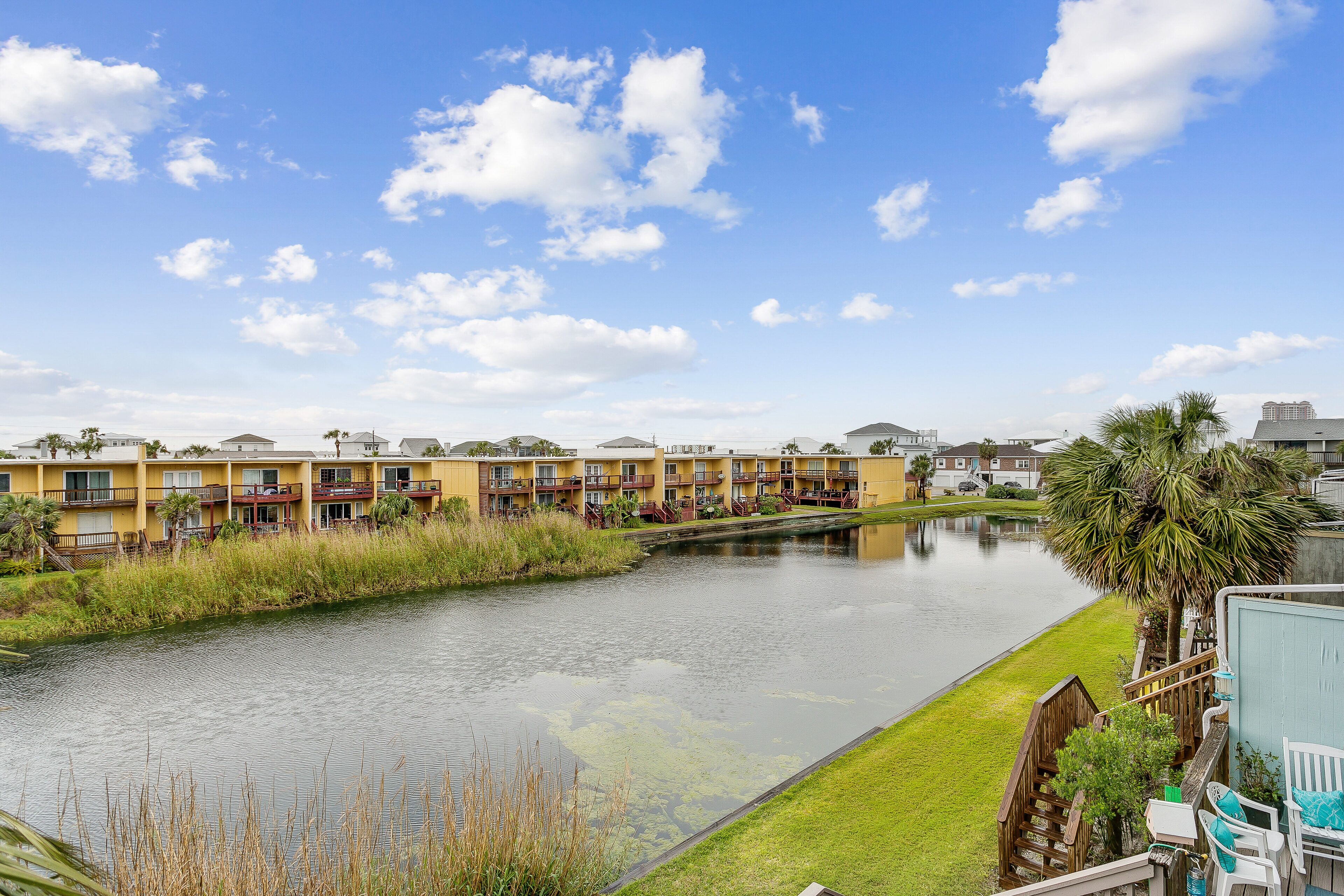 A view of a water body with a row of yellow buildings in the background.
