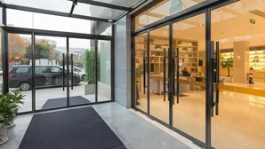 A modern hotel lobby with glass doors, a reception desk, and a seating area. - Deep Sleep Hotel (Xuzhou High-Speed Railway Station Front Square Zhenxing Avenue) (Xuzhou)