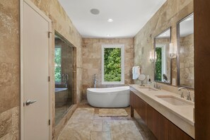 Bathtub, towels, soap, toilet paper