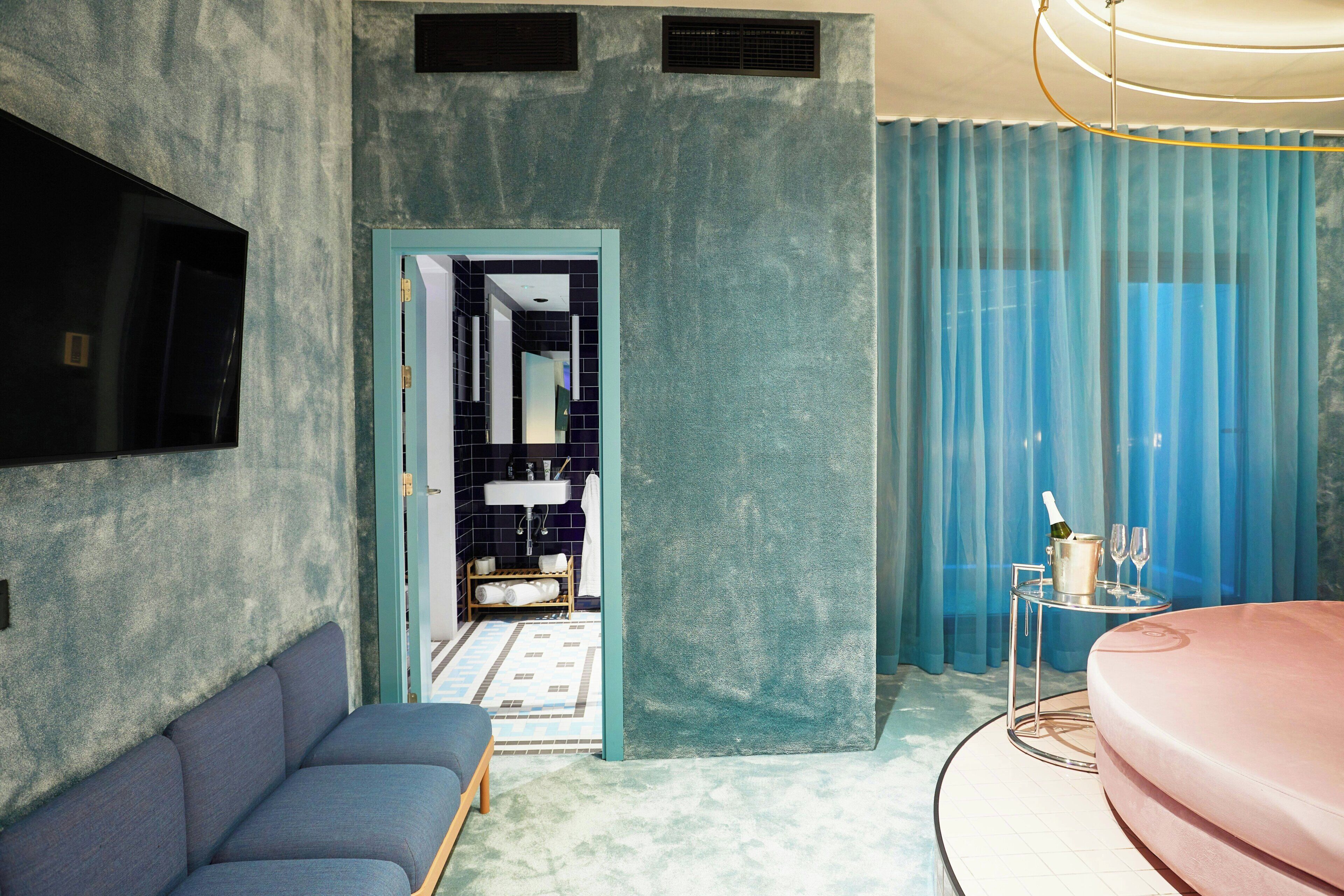 A modern bathroom with a bathtub, a sink, and a shower area.