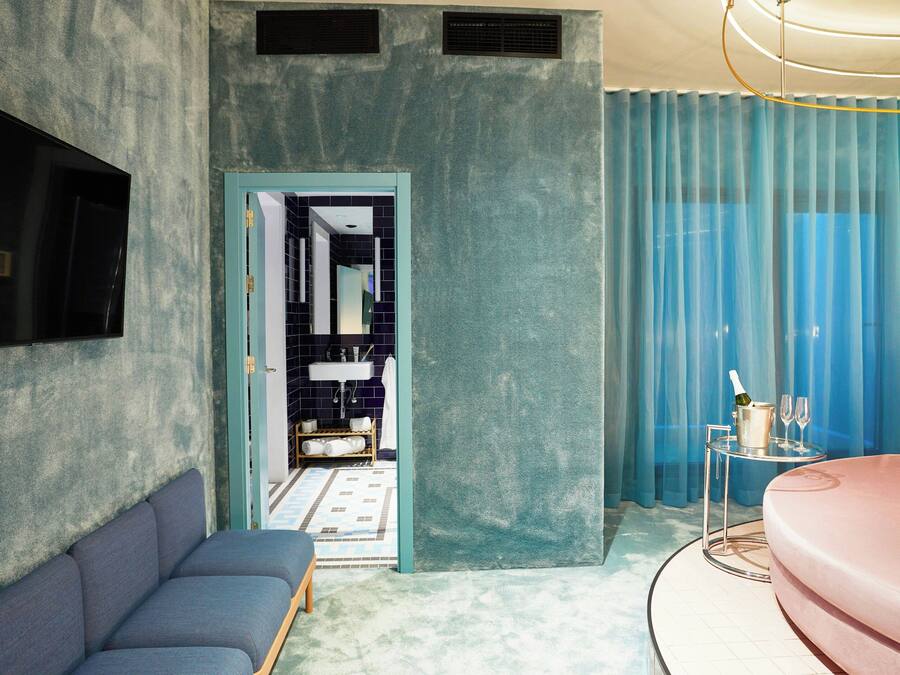 A modern bathroom with a bathtub, a sink, and a shower area.