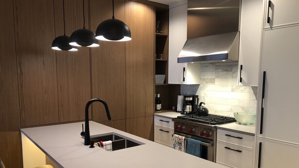A modern kitchen with a central island, stainless steel appliances, and wooden cabinetry. - Luxury Condo - Easy Walk to Downtown, Ocean & Attractions (Victoria)