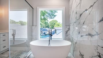 Combined shower/bathtub, towels, soap, toilet paper