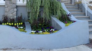 A house with a stone facade, a balcony with a railing, and a staircase leading to the entrance. - Family-Sized with Bay Views and Close to Beach (Ventnor City)