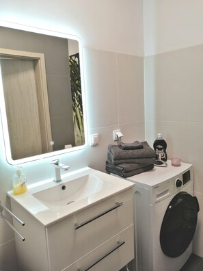 Combined shower/tub, hair dryer, towels, soap