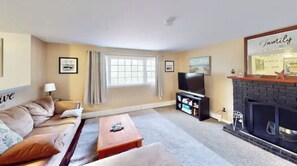 Relax in this inviting living room with a comfortable sofa, coffee table, and flat-screen TV.