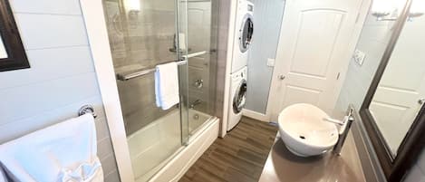 Combined shower/tub, hair dryer, towels, soap