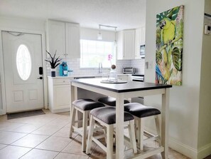Enjoy cooking in this well-equipped kitchen with a central island and bar stools.