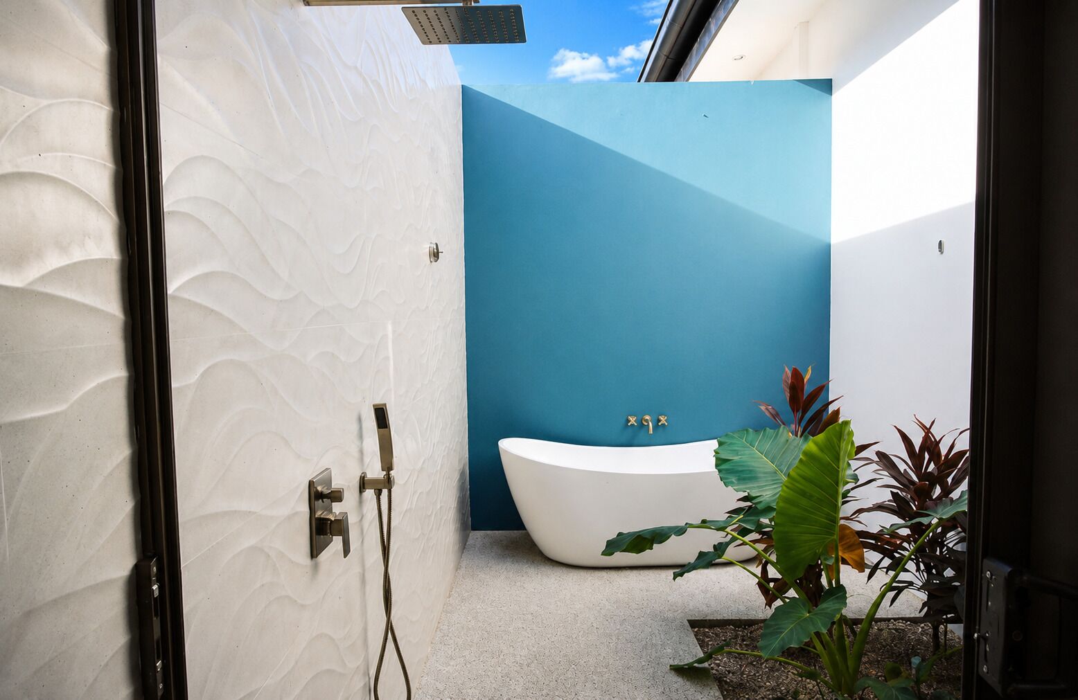 Une salle de bain moderne avec une baignoire sur pieds, une douche et une plante.
