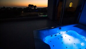 A hot tub with a view of the sunset.