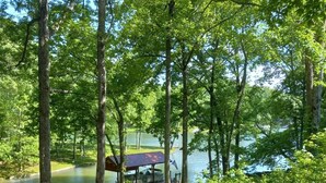A lakeside park with a concrete pathway, picnic tables, and a covered area by the water. - Log Cabin/Cottage on Watts Bar Lake (Ten Mile)