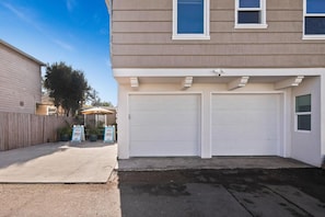 A two-story residential building with two attached garages.