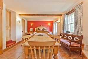 Enjoy meals in this dining room with a long table and comfortable seating for all.