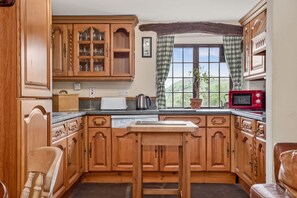 Enjoy cooking in this well-equipped kitchen with a microwave, kettle, and toaster.