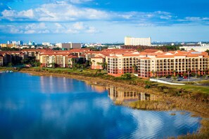 Experience a serene lake view from our hotel complex, surrounded by a mix of urban and natural landscapes.
