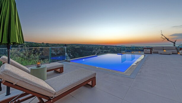 A rooftop pool area with lounge chairs, a glass balustrade, and a sunset view. - Dim Luxury Villa - With Private Pool (Margarites)